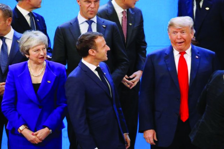 Britain's Prime Minister Theresa May, French President Emmanuel Macron and US President Donald Trump at the G20 summit in Buenos Aires, Argentina on November 30, 2018. —Photo: Reuters