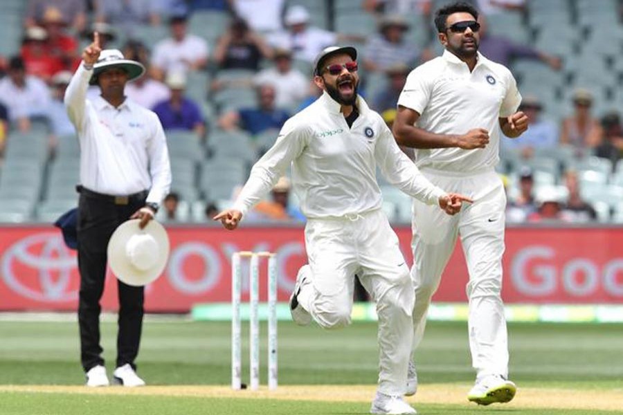India's Virat Kohli and Ravichandran Ashwin celebrating after the dismissal of Marcus Harris of Australia during day two of the first Test against Australia at the Adelaide Oval on Friday — Internet