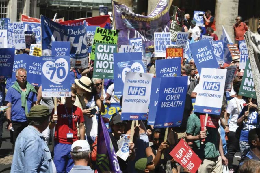 People march in central London to mark the 70th anniversary of the forming of the National Health Service (NHS) on June 30, 2018. Various unions and interested groups gathered to celebrate the forming of the NHS and call for better funding for the British health service. — Photo: AP