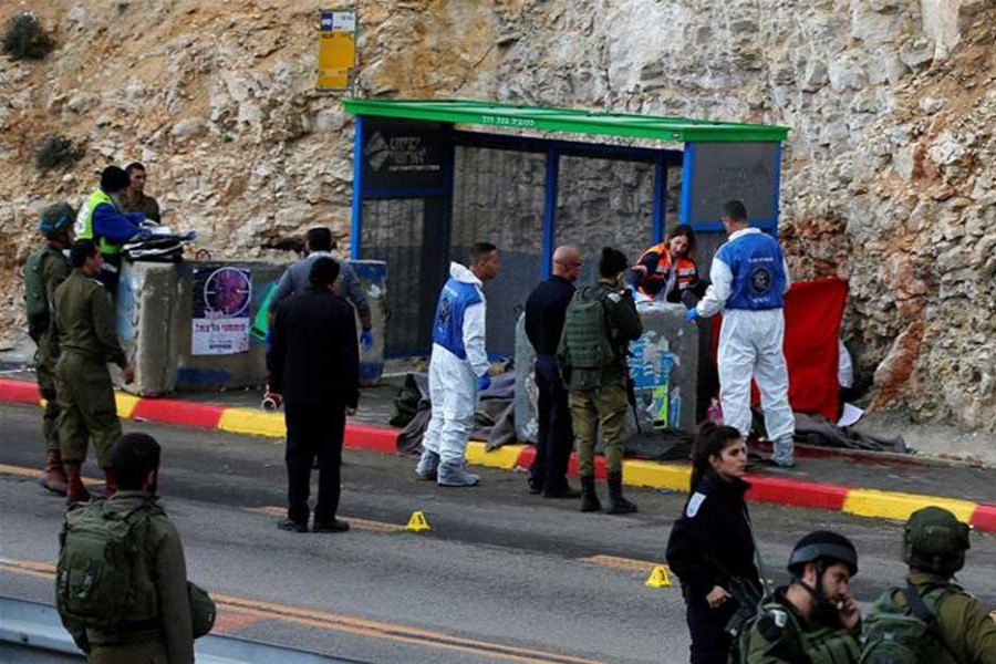 Israeli forces and medics at the scene of a shooting attack near Ramallah in the Israeli-occupied West Bank. - Reuters