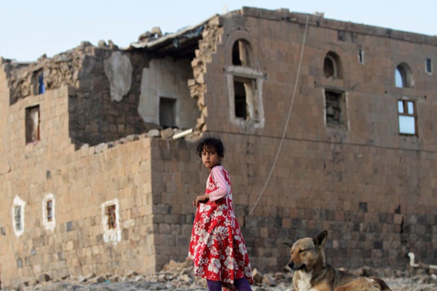 A girl walks near her house destroyed in an air strike carried out by the Saudi-led coalition in Faj Attan village, Sanaa, Yemen, December 13, 2018. Reuters