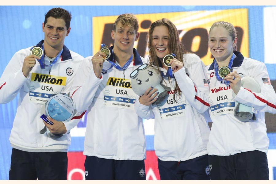 Gold medalist and new world record holders USA team, from left, Michael Andrew, Caeleb Dressel, Olivia Smoglia and Kelsi Dahlia posing during ceremony at the mixed 4x50m medley relay in the 14th FINA World Swimming Championships in Hangzhou in eastern China's Zhejiang Province on Thursday — AP