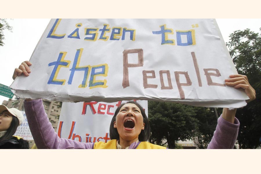 TAIPEI: A protester shouting slogans demanding tax reform outside the Ministry of Finance in Taipei on Thursday — AP