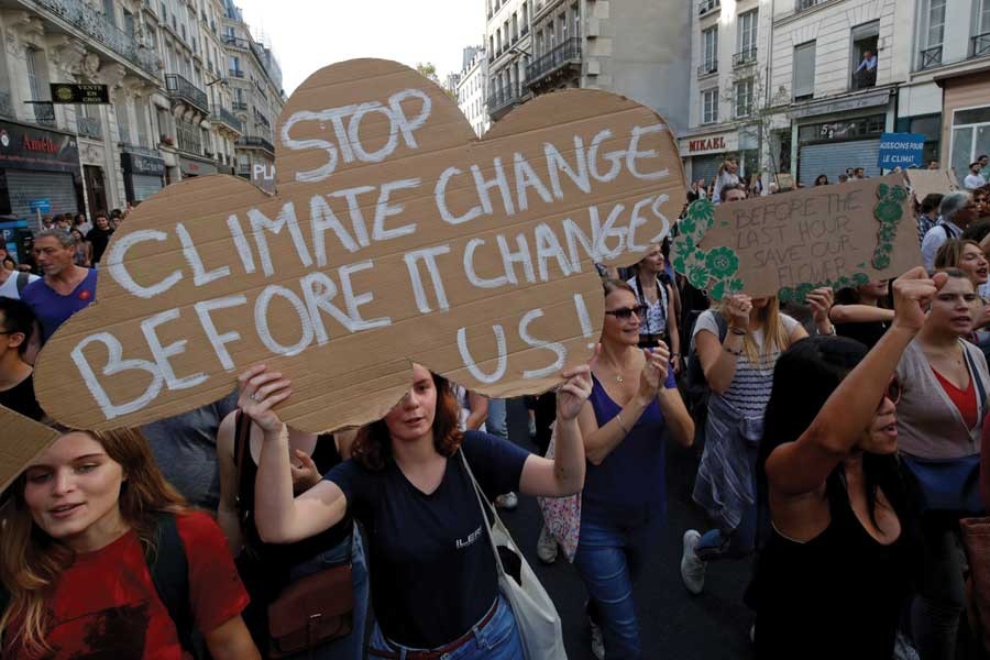 Protesters march to urge politicians to act against climate change in Paris on October 13, 2018. — Reuters