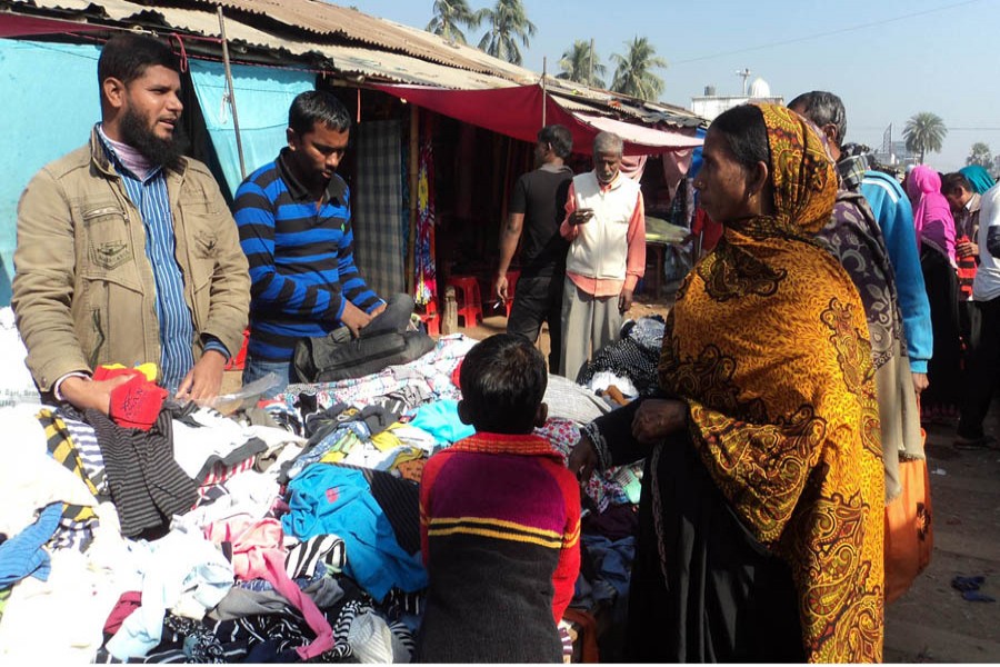 Cold-hit people from different areas purchasing warm clothes from Shapla Super Market in Sadar Upazila of Bogura district. — FE Photo