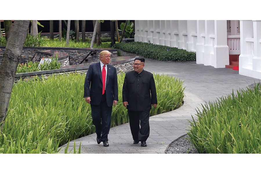 US President Donald Trump walks with North Korean leader Kim Jong Un at the Capella Hotel on Sentosa island in Singapore on June 12, 2018. —Photo: Reuters
