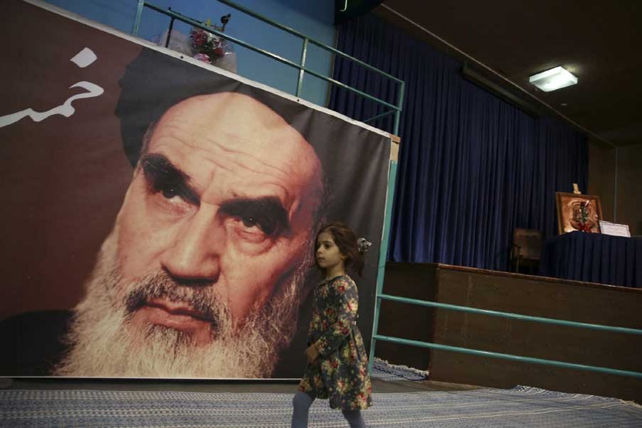 In this Tuesday, Jan. 22, 2019, photo, a girl walks past a poster of Ayatollah Ruhollah Khomeini, at a mosque where he made speeches, in northern Tehran, Iran. – AP photo