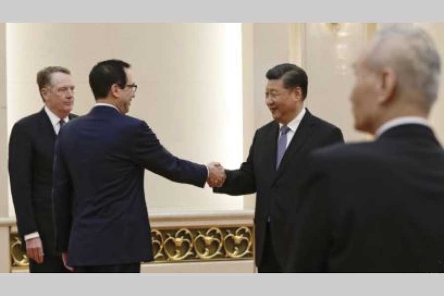 US Treasury Secretary Steven Mnuchin, second from left, shakes hands with Chinese President Xi Jinping as US. Trade Representative Robert Lighthizer, left, and Chinese Vice Premier Liu He, right, look on before their meeting at the Great Hall of the People in Beijing on February 15, 2019 — AP