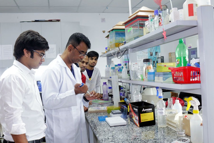 Prof Dr Abu Reza working at a laboratory at RU — FE Photo