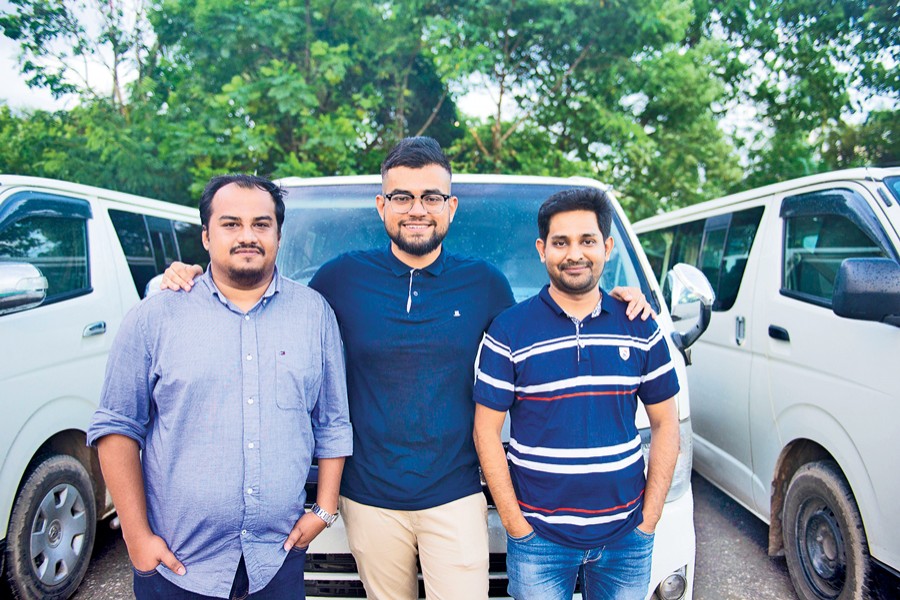 Founders of Shuttle, an app based transport service for professional women: Jawwad Jahangir (left), Reyasat Chowdhury (middle) and Shah Sufian Mahmud Chowdhury (right); their Shuttle microbuses can be seen at the back