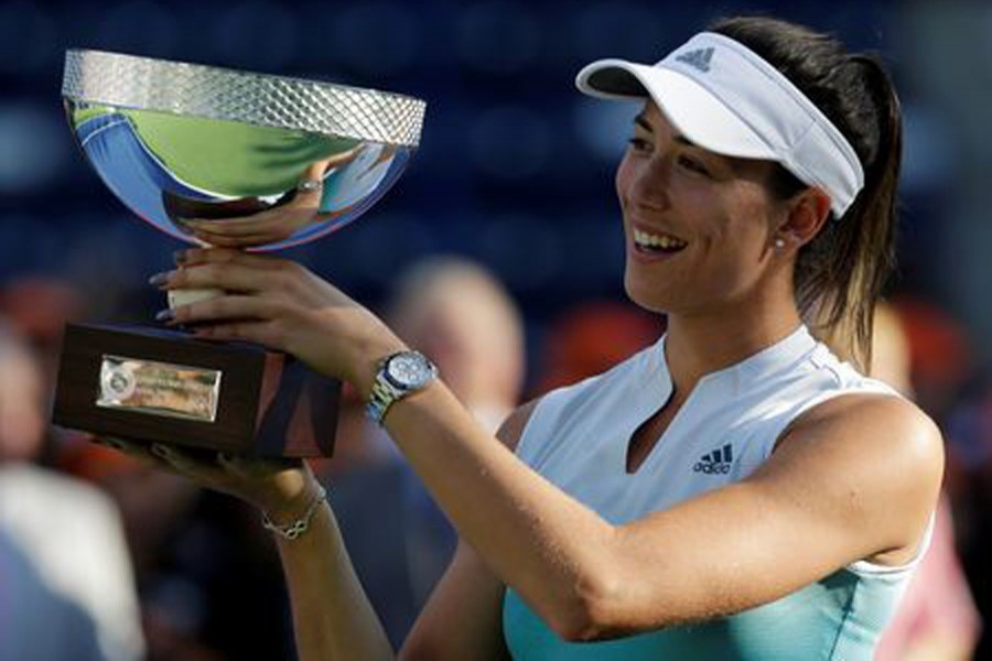 Spain's Garbine Muguruza holding the trophy after winning the Monterrey Open final on Sunday — Reuters