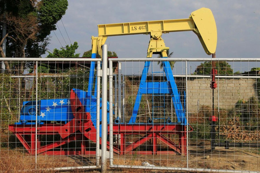 An oil pumpjack painted with the colors of the Venezuelan flag is seen in Lagunillas, Venezuela — Reuters