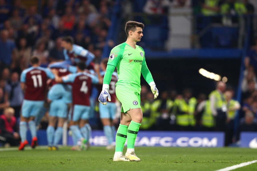 Chelsea's Kepa Arrizabalaga looking crestfallen as Burnley celebrate their first-half equaliser in the Premier League on Monday — Internet