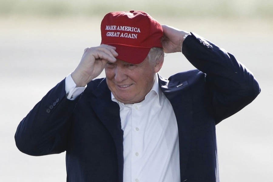 Donald Trump, then Republican presidential candidate, wears his "Make America Great Again" hat at a rally in Sacramento, California in June 2016. —Photo: AP