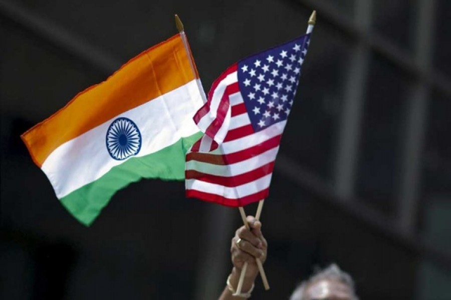 A man holds the flags of India and the US while people take part in the 35th India Day Parade in New York August 16, 2015. Reuters/Files
