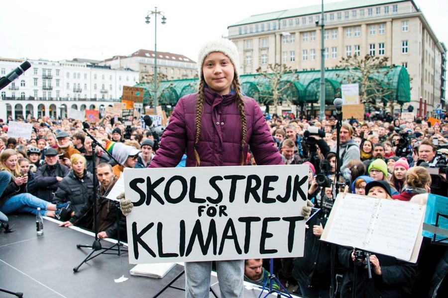 Swedish climate activist Greta Thunberg holds a sign reading, "School strike for the climate," as she attends a rally in Hamburg, Germany on March 01, 2019. —Photo: AP