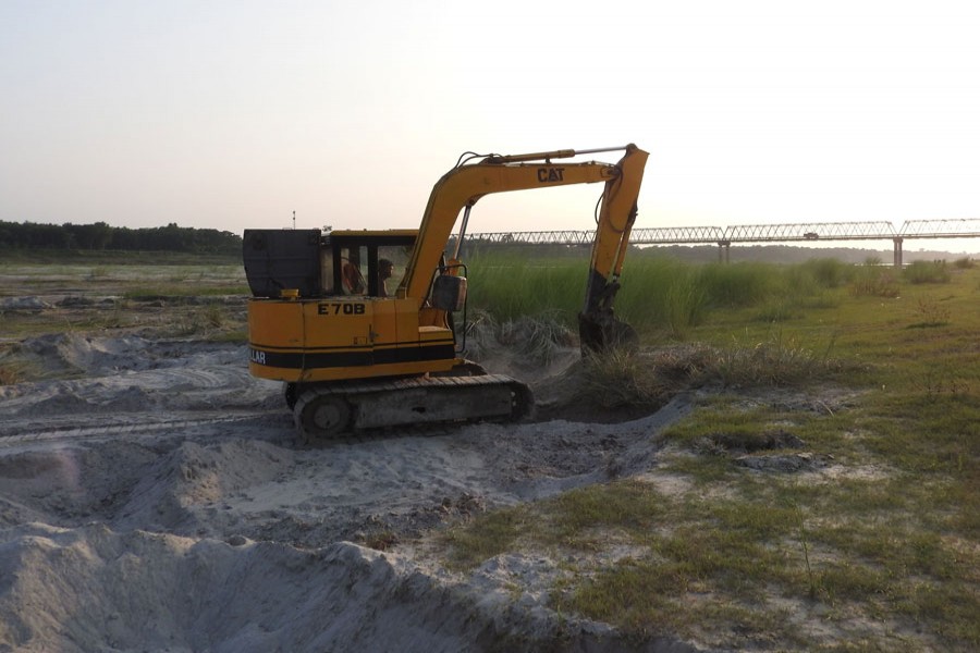 Sand lifting is going on by an excavator near the Gorai Bridge in Magura. The photograph was taken on Thursday — FE Photo