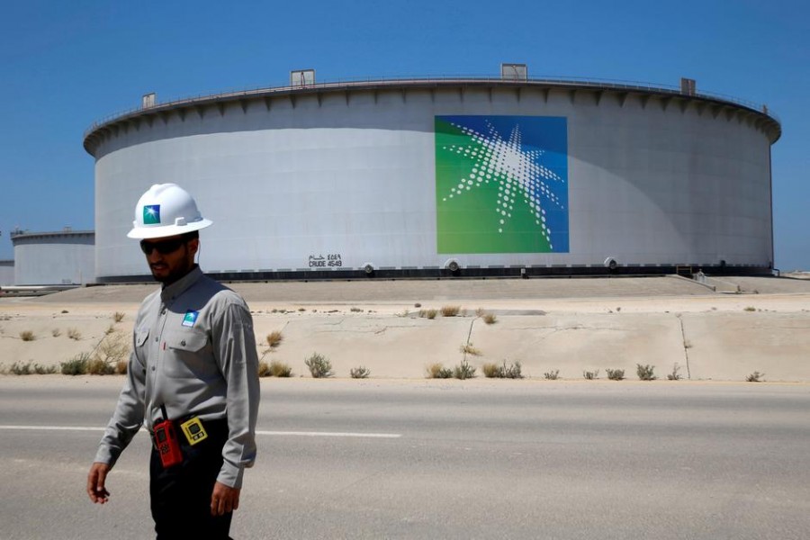 An Aramco employee walks near an oil tank at Saudi Aramco's Ras Tanura oil refinery and oil terminal in Saudi Arabia, May 21, 2018. Reuters/File Photo