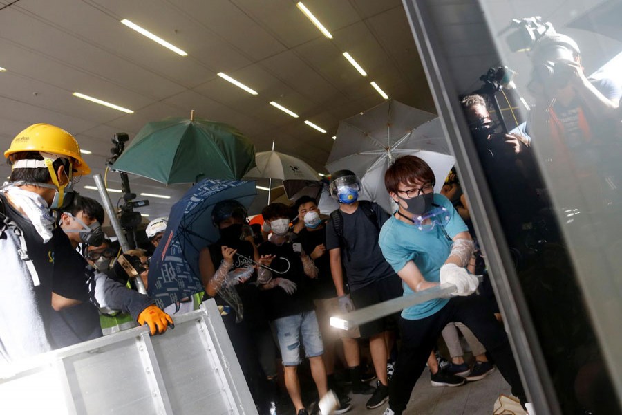 Protesters breaking into the Legislative Council building during the anniversary of Hong Kong's handover to China in Hong Kong, China on Monday — Reuters