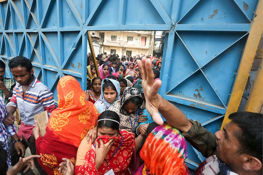 Workers of a garment factory in Dhaka seen joining their workplace, ending their mass protests, after a revision in the wage structure — FE/files