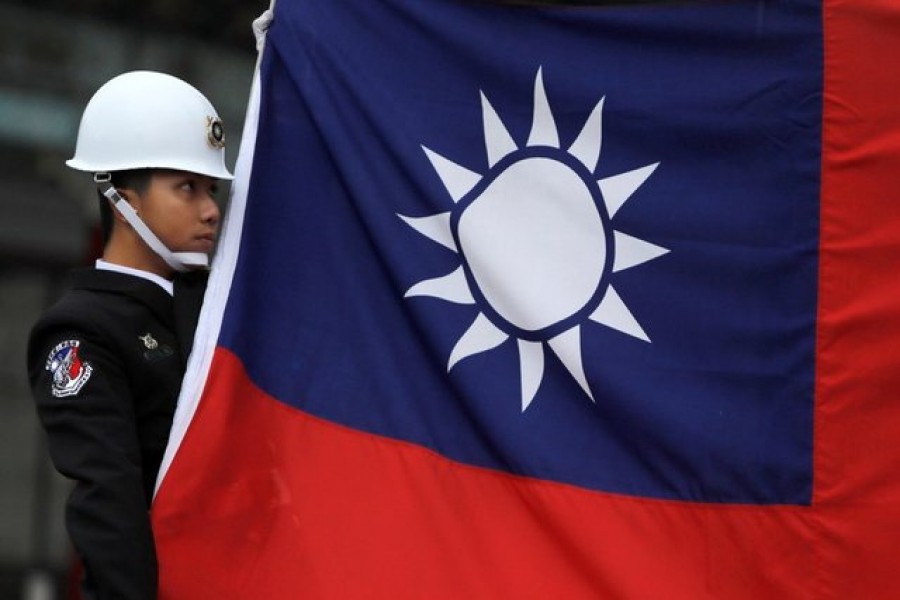 A military honour guard holds a Taiwanese national flag as he is attending flag-raising ceremony at Chiang Kai-shek Memorial Hall, in Taipei, Taiwan, March 16, 2018. Reuters/File Photo