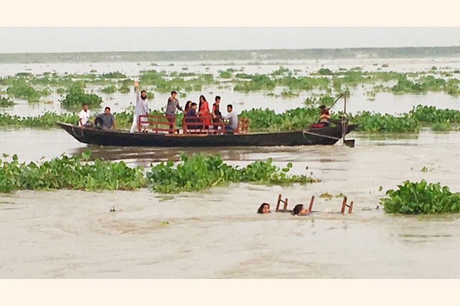 Two female passengers floating in the Padma as they fell off a boat near Sreerampore area in Rajshahi on Sunday — FE Photo