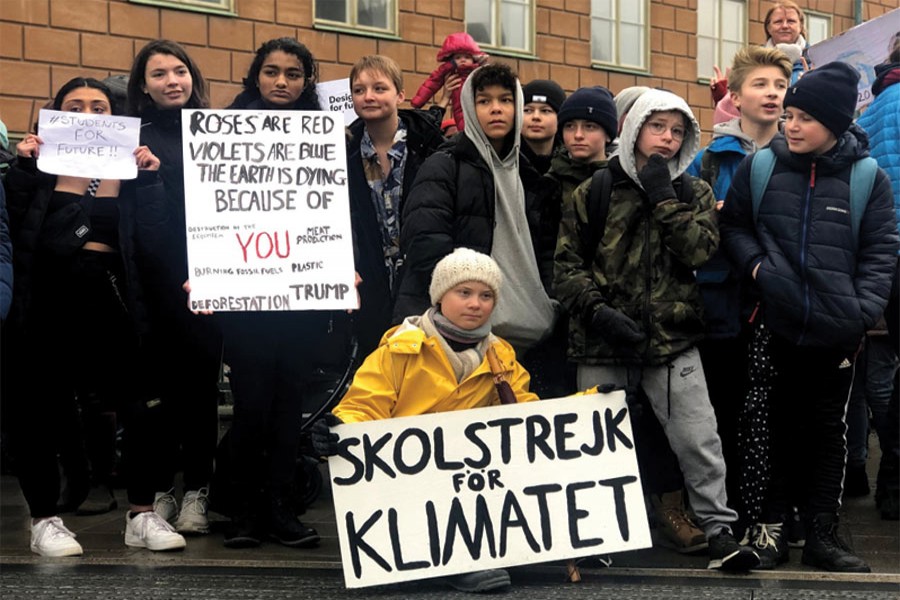 Swedish 16-year-old environmental activist Greta Thunberg (in the front) attends a protest next to Sweden's parliament in Stockholm, Sweden, on March 08, 2019. The sign reads 'School strike for the climate'. —Photo: Reuters 'A young Swedish girl, Greta Thunberg, has done more with her stubbornness to raise awareness about impending climate change than the entire political system. Even Trump (albeit for electoral reasons) has now declared that climate change is important.'