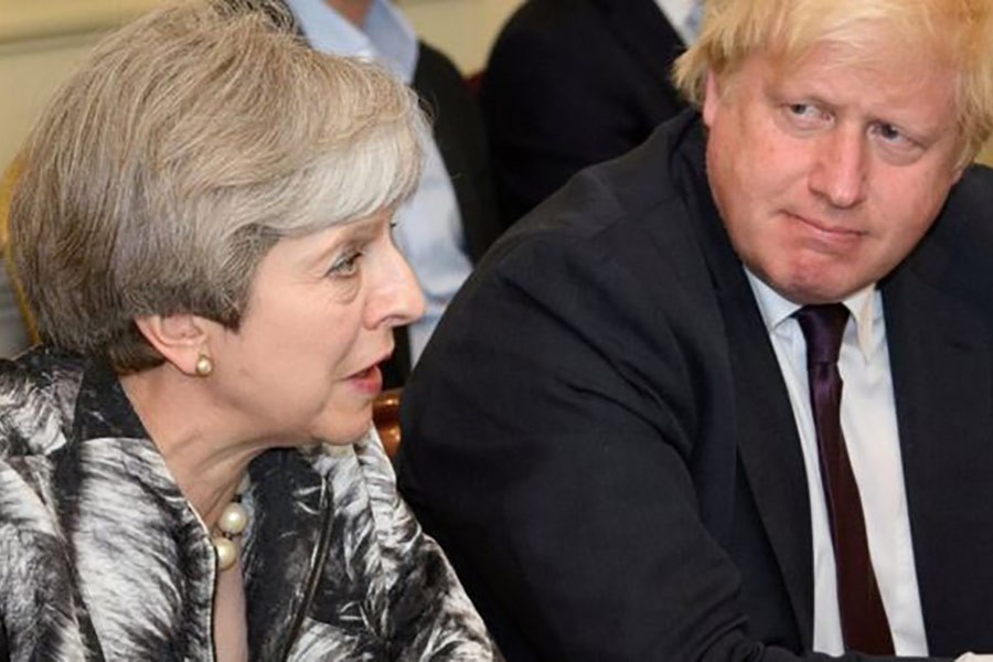 Boris Johnson (right), then foreign secretary, left the government of Theresa May in 2018 over her Chequers Brexit plan. —Photo: Reuters