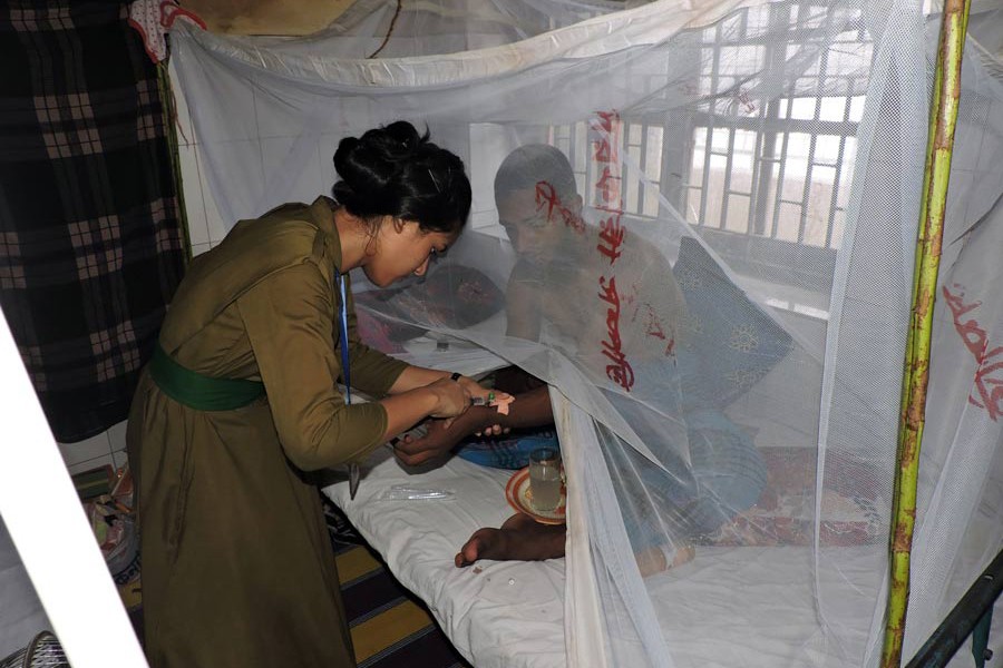 A nurse pushing an injection to a dengue-affected patient at Magura 250-bed hospital on Sunday — FE Photo