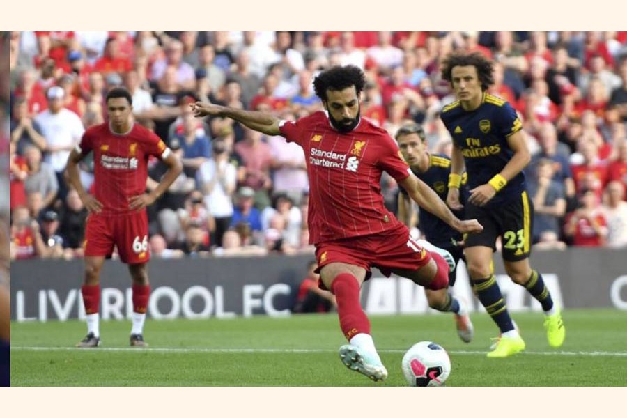 Liverpool's Mohamed Salah scored his side's second goal of the game from the penalty spot during the English Premier League football match against Arsenal at Anfield in England on Saturday — AP