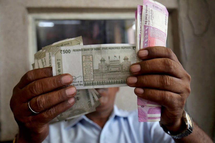 A cashier checks Indian rupee notes inside a room at a fuel station in Ahmedabad, September 20, 2018. Reuters/File Photo