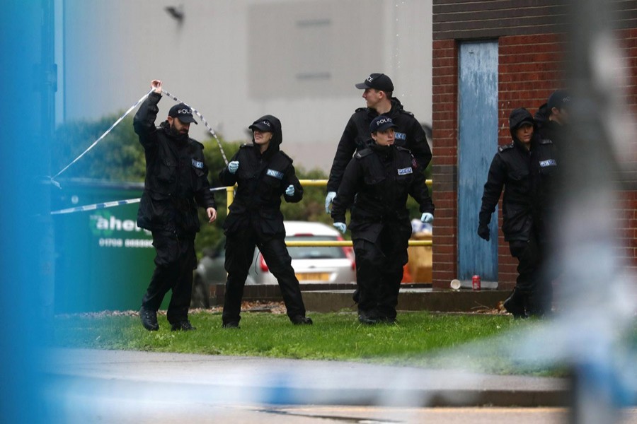 Police officers are seen at the scene where bodies were discovered in a lorry container, in Grays, Essex, Britain, October 24, 2019. Reuters