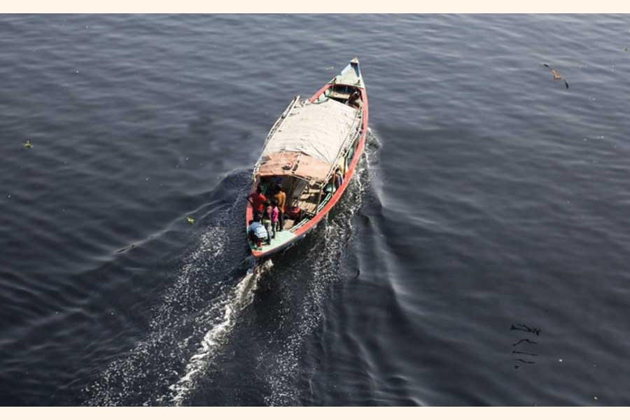 DHAKA PUMPS 1.1 MILLION CUBIC METRES OF SEWAGE INTO RIVERS DAILY, STUDY SAYS: A boat moves across the polluted waters of the Buriganga River, as viewed from the Bangladesh China Friendship Bridge in Dhaka's Postogola. The poisonous black water bears testimony to the environmental degradation inflicted upon it akin to three other rivers around the capital. —bdnews24.com, May 29, 2019
