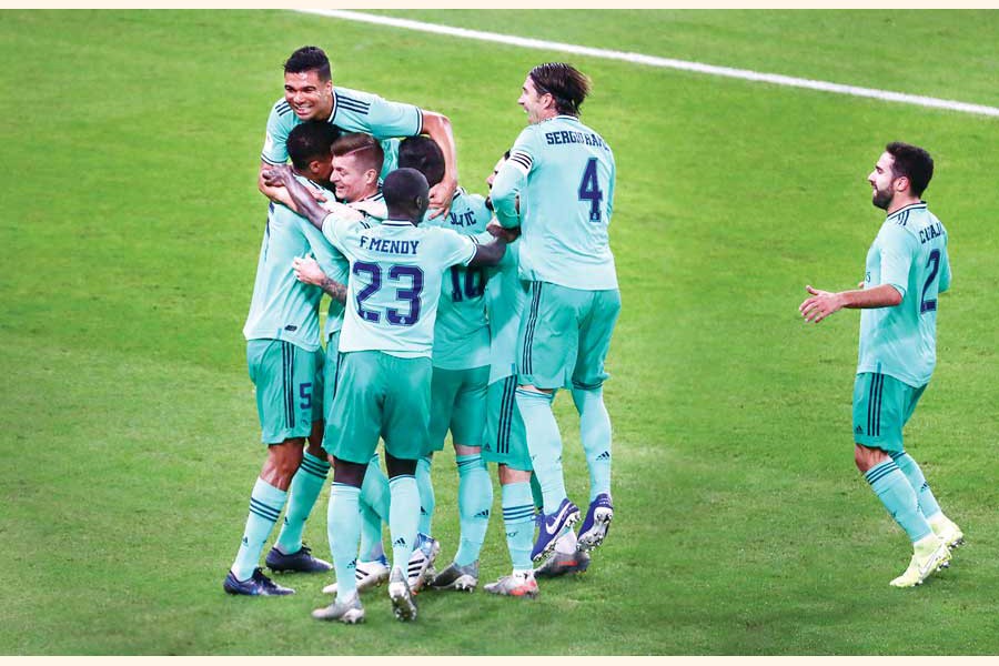 Real Madrid's Toni Kroos celebrating with teammates after scoring their first goal during the Spanish Super Cup match against Valencia on Wednesday — Reuters