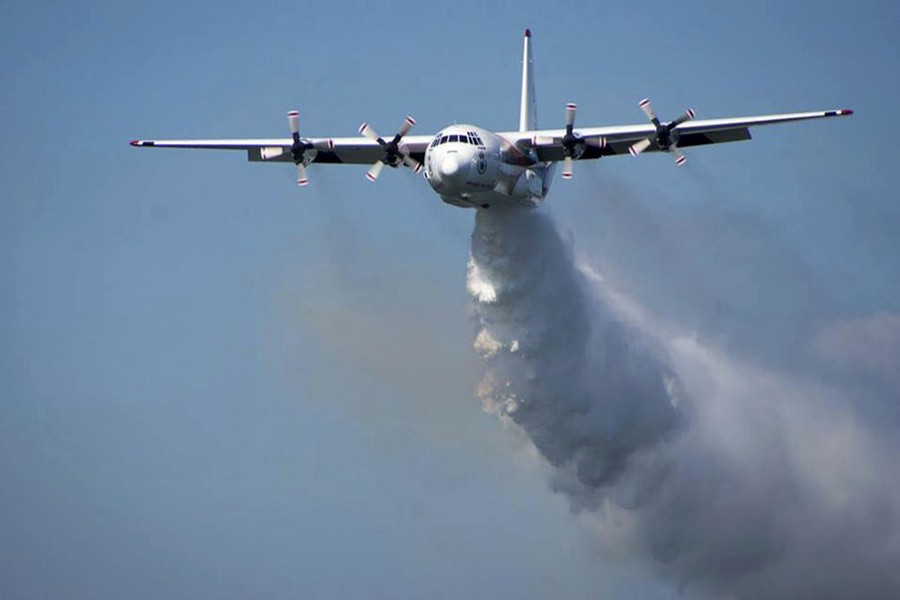 In this undated photo released from the Rural Fire Service, a C-130 Hercules plane called 'Thor' drops water during a flight in Australia. Picture used only for representation — RFS via AP