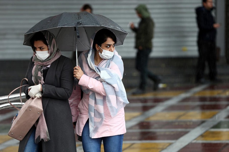 Iranian women wear protective masks to prevent contracting coronavirus, as they walk in the street in Tehran, Iran on February 25, 2020 — West Asia News Agency via REUTERS