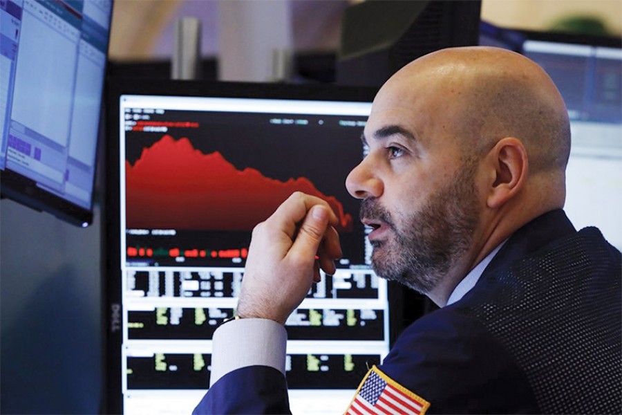 Trader Fred DeMarco works on the floor of the New York Stock Exchange on Februry 28, 2020. Global stock markets are falling further on spreading virus fears. — Photo: AP