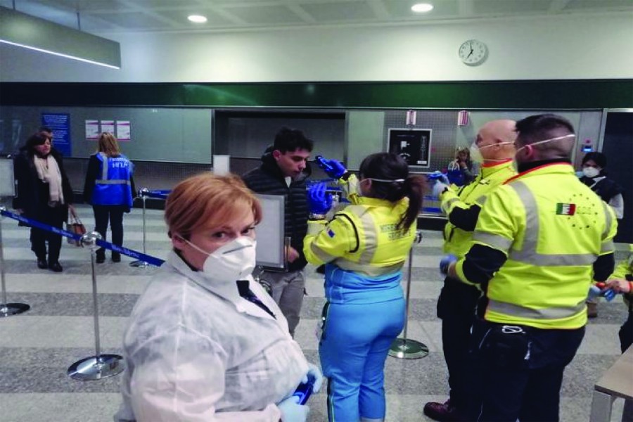 Civil protection volunteers engaged in health checks at the "Milano Malpensa" airport. This week a joint team between WHO and the European Centre for Disease Prevention and Control arrived in Rome to review the public health measures put in place to prevent the spread of the coronavirus. —Courtesy: Dipartimento Protezione Civile