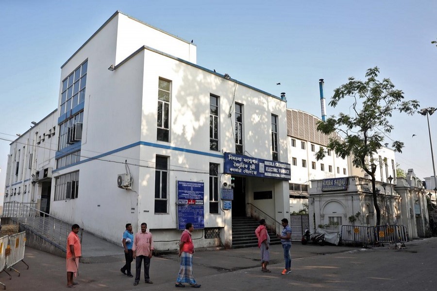 People stand outside Nimtala Crematorium, where a coronavirus positive patient Samir Kumar Mitra was cremated on March 23, in Kolkata, March 27, 2020. — Reuters