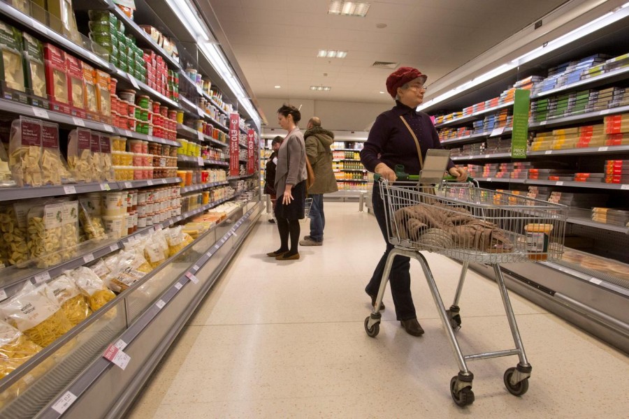 FILE PHOTO: Shoppers browse the aisles in the Canary Wharf store of Waitrose in London January 23, 2013. REUTERS/Neil Hall/File Photo