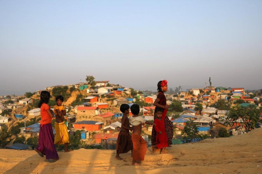 Rohingya refugee children walk along the road at Balukhali camp in Cox’s Bazar, Bangladesh, November 16, 2018. REUTERS/File Photo