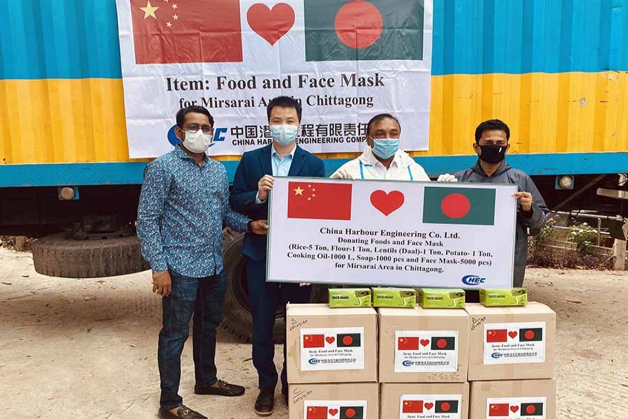 Wan Yanchao, project manager of China Harbour Engineering Company Ltd (CHEC) distributing food and corona prevention stuff to Ruhul Amin, Upazila Nirbahi Officer and Md Jasim Uddin, chairman, Mirsarai Upazila at Upazila Parishad Office on Sunaday