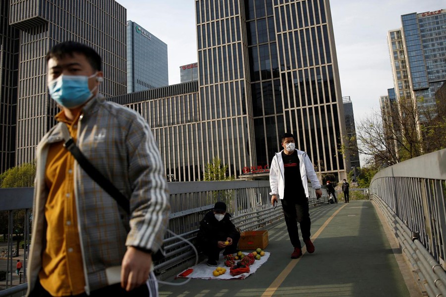 People wearing face masks walk on an overpass in Beijing's central business area, amid an outbreak of the novel coronavirus disease (COVID-19) in the country, China on April 5, 2020 — Reuters photo