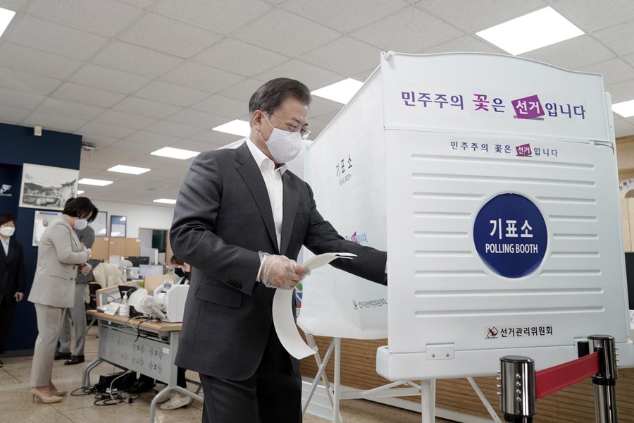 South Korean President Moon Jae-in wearing a mask and a plastic gloves to prevent contracting the coronavirus disease (COVID-19), arrives to cast his absentee ballot at a polling station for parliamentary election in Seoul, South Korea on April 10, 2020 — Yonhap via REUTERS