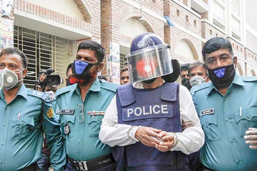Abdul Mazed (wearing helmet) being taken to the CMM's court in the city on Tuesday — Focus Bangla