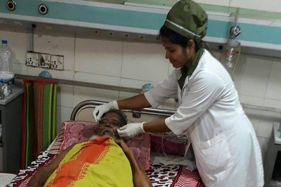 In this undated photo, a female nurse is seen taking care of a patient at a medical facility. – UNB Photo