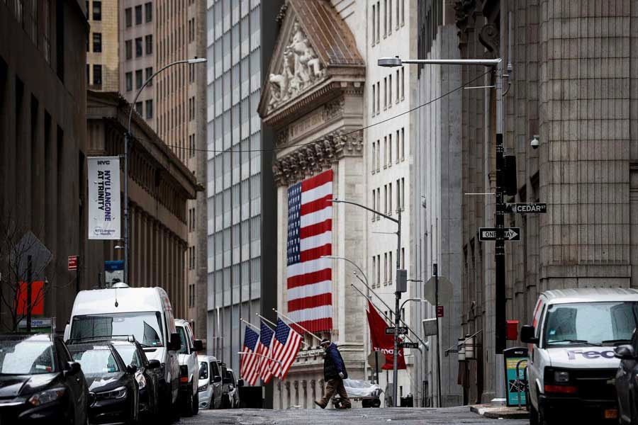 A man crosses a nearly deserted Nassau Street in front of the New York Stock Exchange (NYSE) in the financial district of lower Manhattan during the outbreak of the coronavirus disease (Covid-19) in New York City, New York, US on April 03, 2020. -—Photo: Reuters