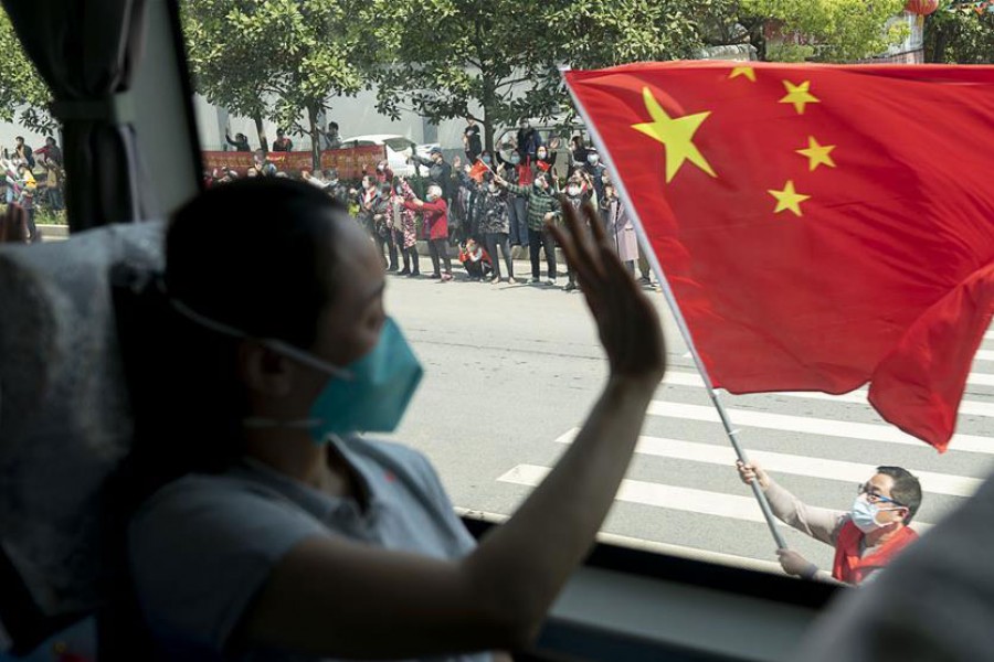 Citizens bid farewell to medics from the Peking Union Medical College Hospital in Wuhan, capital of central China's Hubei Province, April 15, 2020. The last medical assistance team started leaving Hubei Province Wednesday as the COVID-19 epidemic in the hard-hit province has been subdued. The medical team consisting of over 180 medical workers from the Peking Union Medical College Hospital arrived in the provincial capital of Wuhan on Jan. 26. (Xinhua/Xiong Qi)