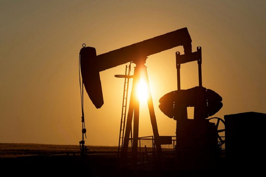 An oil pump jack pumps oil in a field near Calgary, Alberta, Canada, July 21, 2014. — Reuters