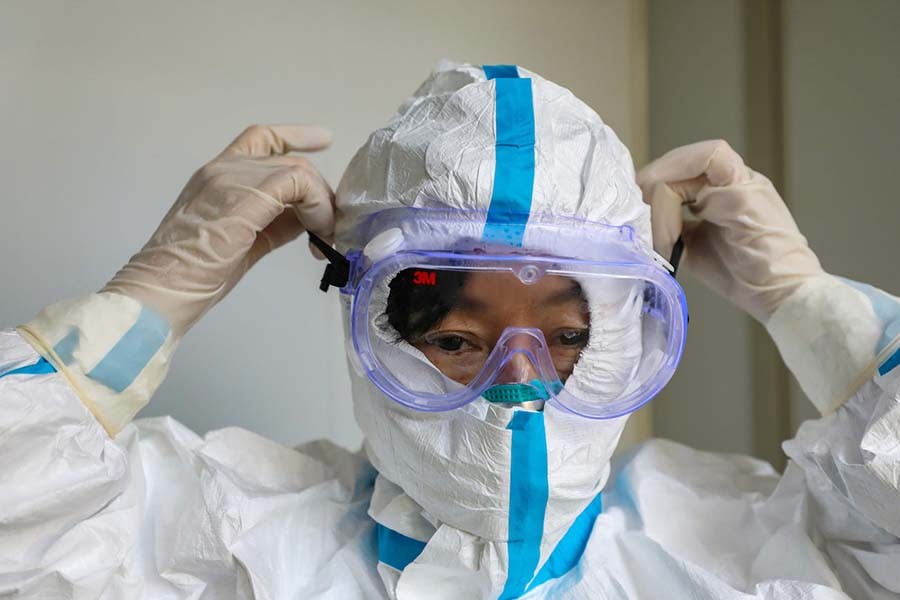 A doctor puts on protective goggles before entering the isolation ward at a hospital, following the outbreak of a new coronavirus in Wuhan, Hubei province, China on January 30, 2020. Reuters